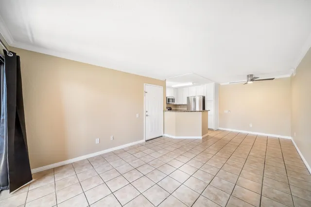 a view of empty room with wooden floor and cabinet