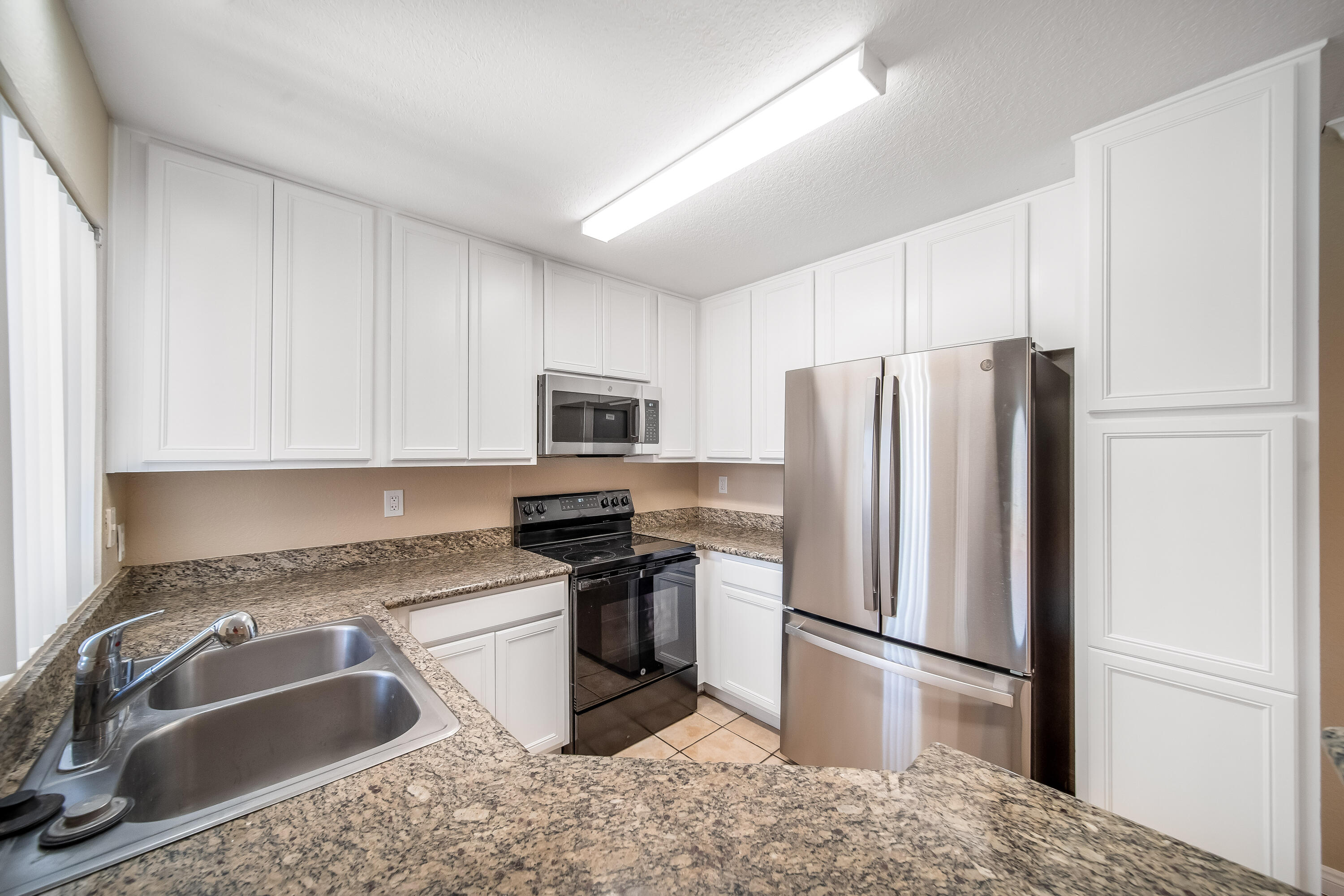 78650 Ave 42, Unit 1407 Bermuda Dunes, CA 92203 - Photo 6 of 20 a kitchen with stainless steel appliances granite countertop a refrigerator sink and stove