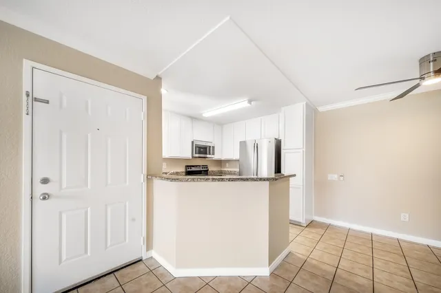 a kitchen with stainless steel appliances a refrigerator and a stove top oven