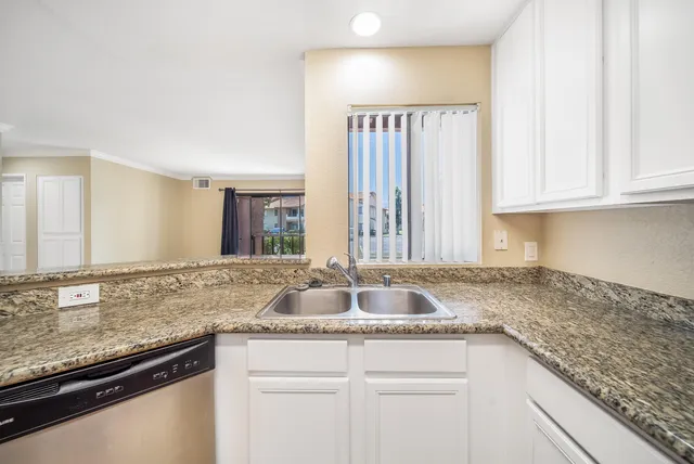 a kitchen with granite countertop a sink and a granite counter tops