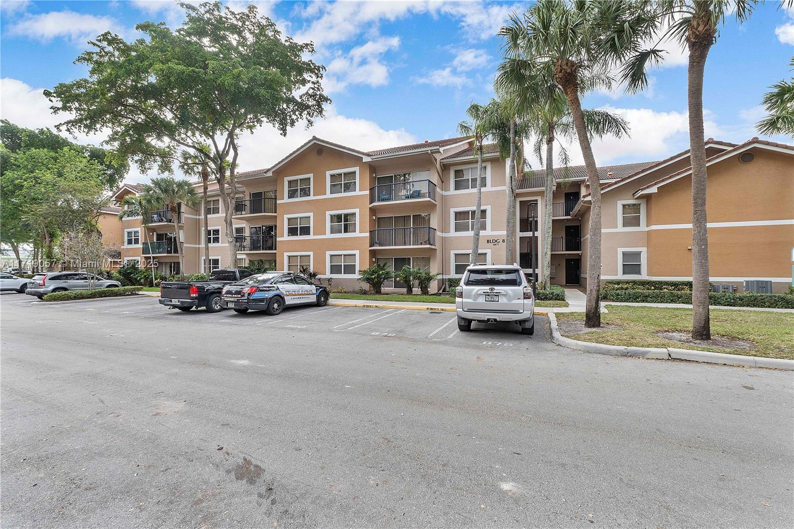 8871 Wiles Road, Unit 204 Coral Springs, FL 33067 - Photo 1 of 25 a car parked in front of a building