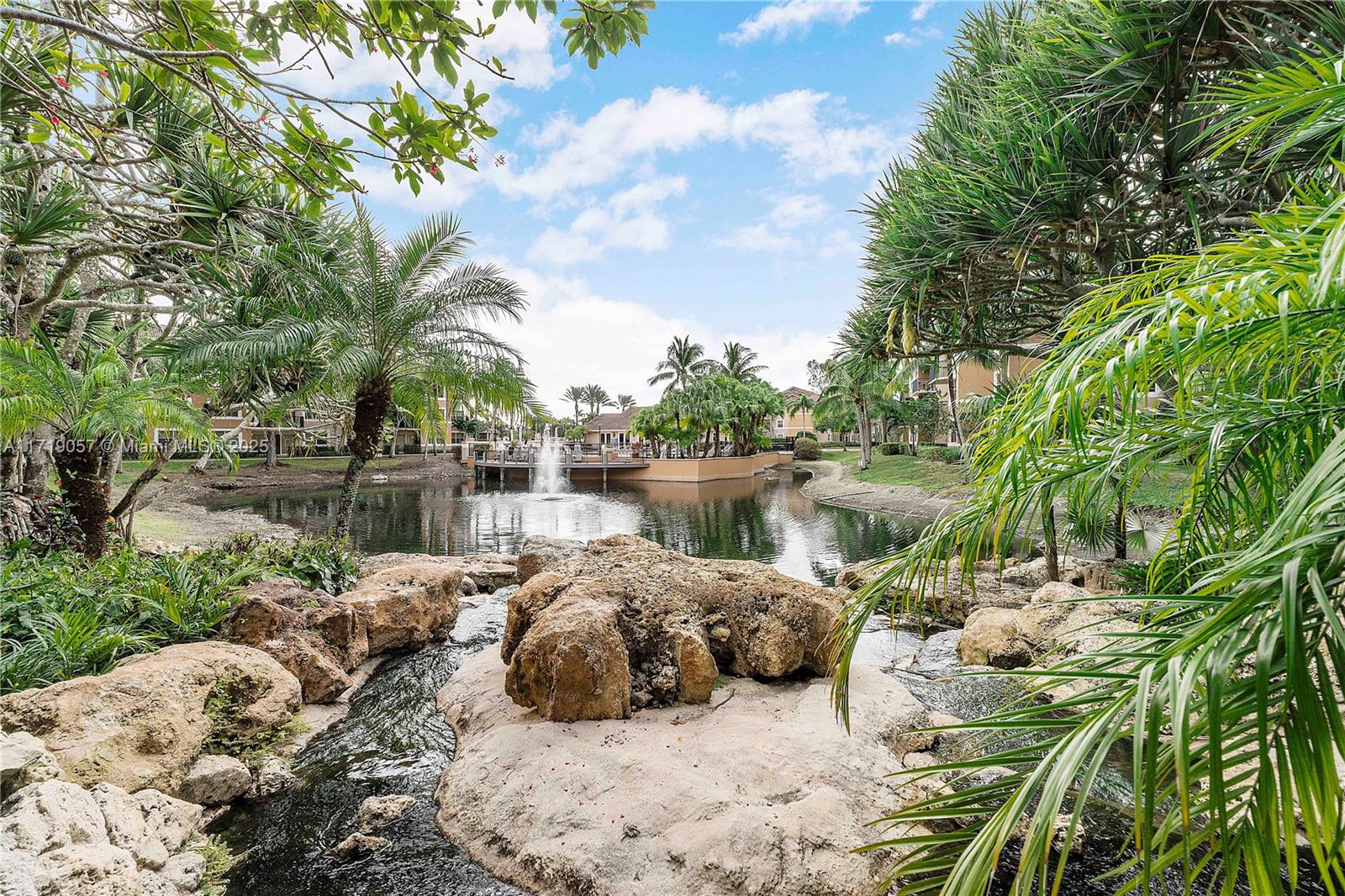 8871 Wiles Road, Unit 204 Coral Springs, FL 33067 - Photo 25 of 25 a view of a lake with a large tree