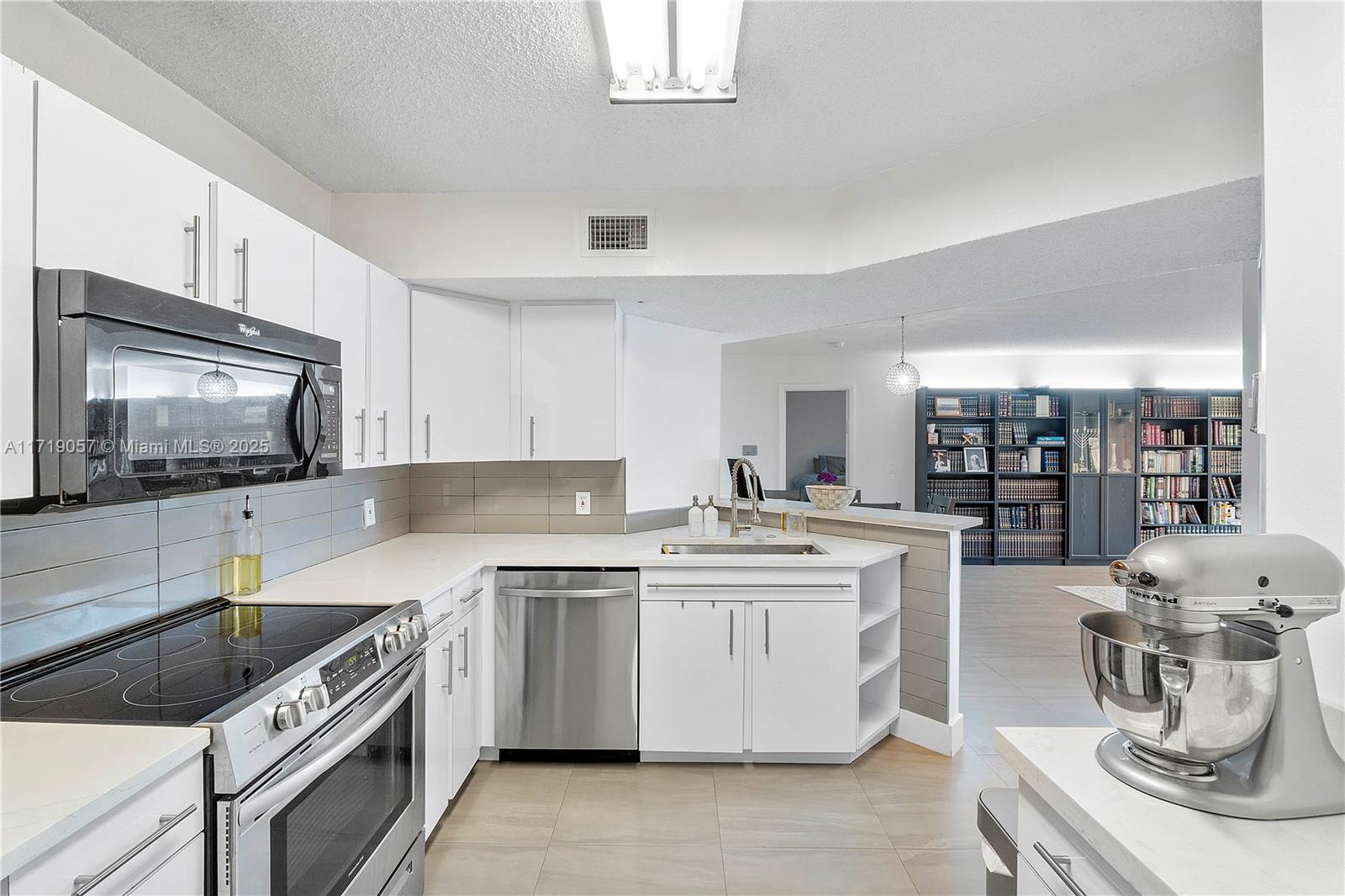 8871 Wiles Road, Unit 204 Coral Springs, FL 33067 - Photo 3 of 25 a kitchen with a stove top oven sink and cabinets