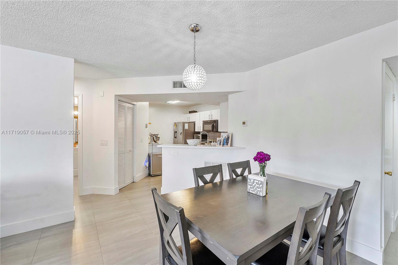 8871 Wiles Road, Unit 204 Coral Springs, FL 33067 - Photo 7 of 25 a view of a dining room with furniture and wooden floor