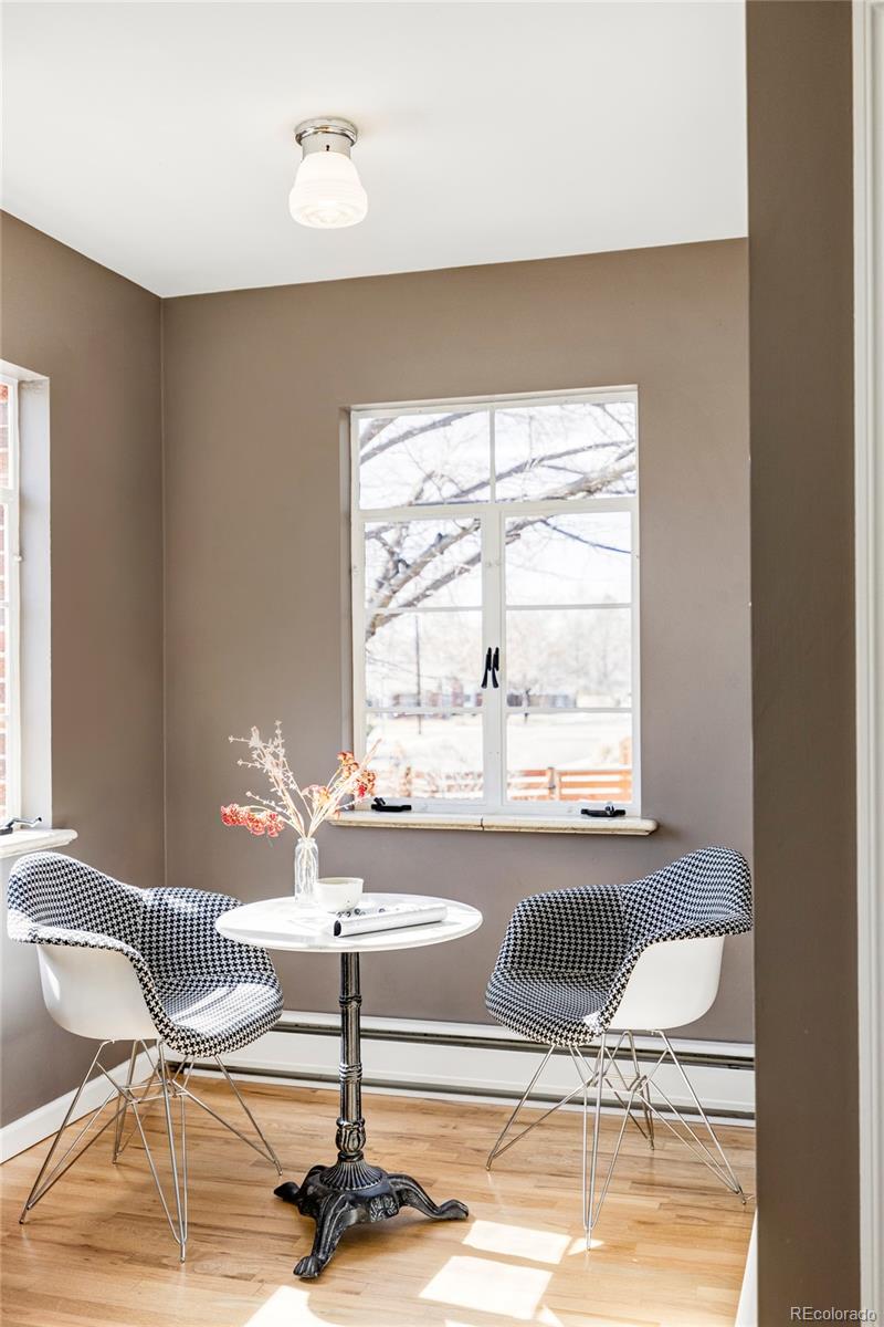 1201 Fairfax Street Denver, CO 80220 - Photo 17 of 40 a dining room with wooden floor and a floor to ceiling window