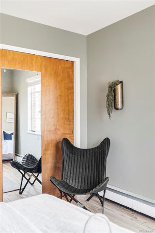a living room with furniture wooden floor and a window