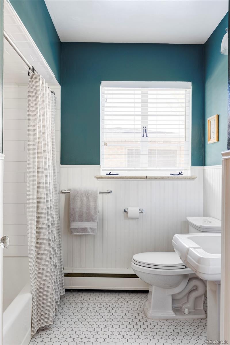 1201 Fairfax Street Denver, CO 80220 - Photo 24 of 40 a bathroom with a toilet a sink and a window