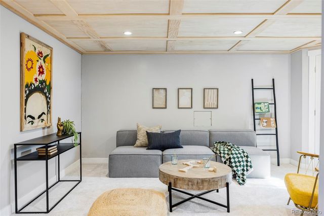 a living room with furniture a rug and a window