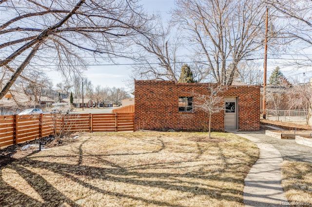 a view of a yard covered with snow in front of house