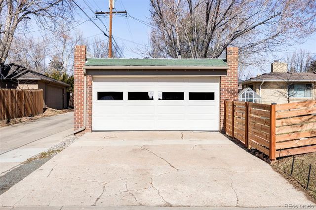 a view of garage with large tree