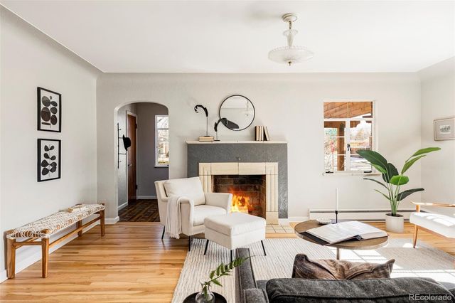 a living room with furniture and a fireplace