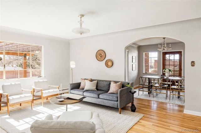 a living room with furniture and wooden floor