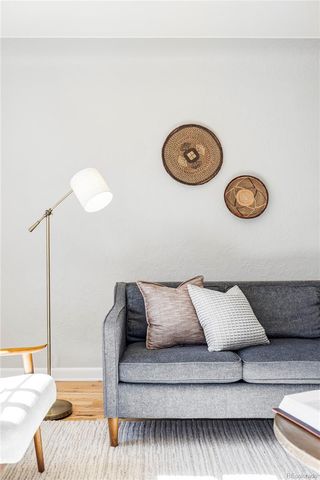 a living room with a couch and chandelier