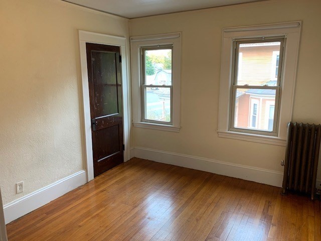 237 Bridge Street Northampton, MA 01060 - Photo 11 of 14 an empty room with wooden floor and windows