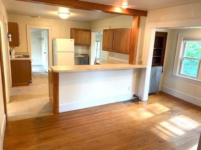 237 Bridge Street Northampton, MA 01060 - Photo 4 of 14 a view of a kitchen with wooden floor and a refrigerator