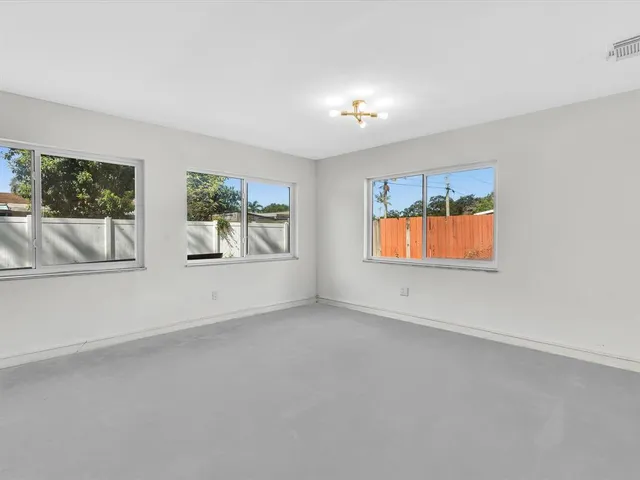 a kitchen with kitchen island granite countertop a sink and a counter top space