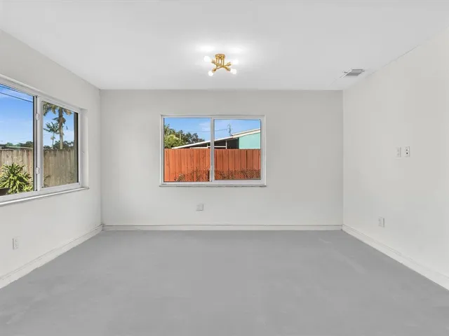 a kitchen with stainless steel appliances granite countertop a sink a refrigerator and a granite counter tops