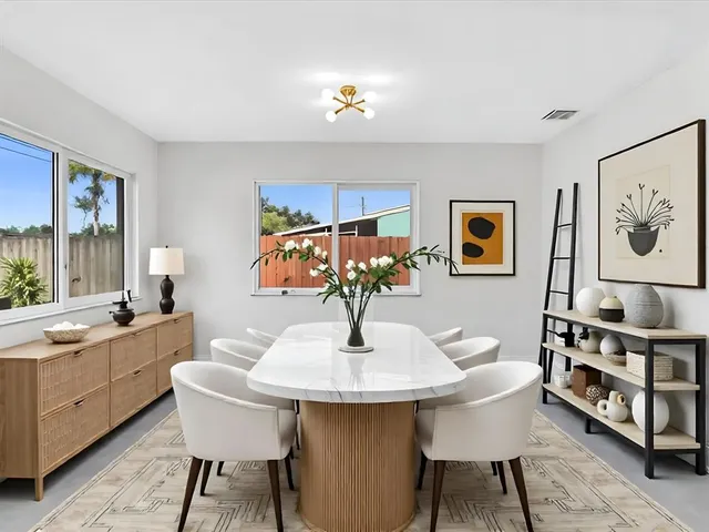 a kitchen with stainless steel appliances kitchen island granite countertop a refrigerator and a stove top oven