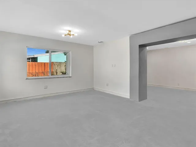 a view of a living room with a large window