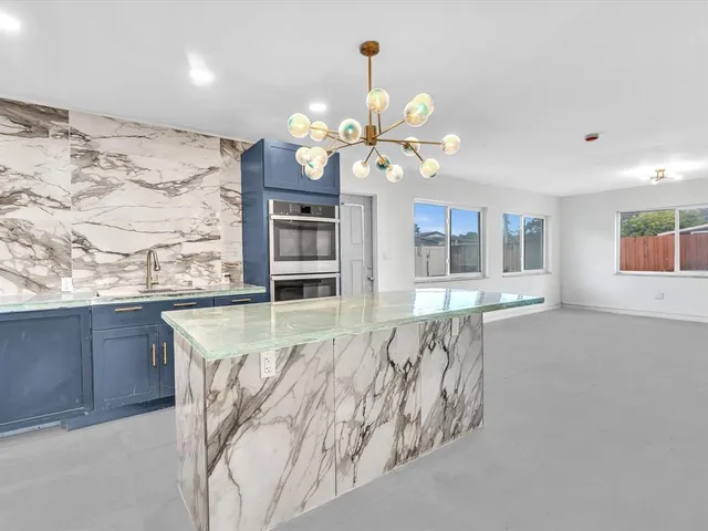 a view of an empty room with ceiling fan