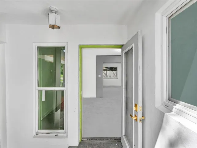 an empty room with a empty space and a window