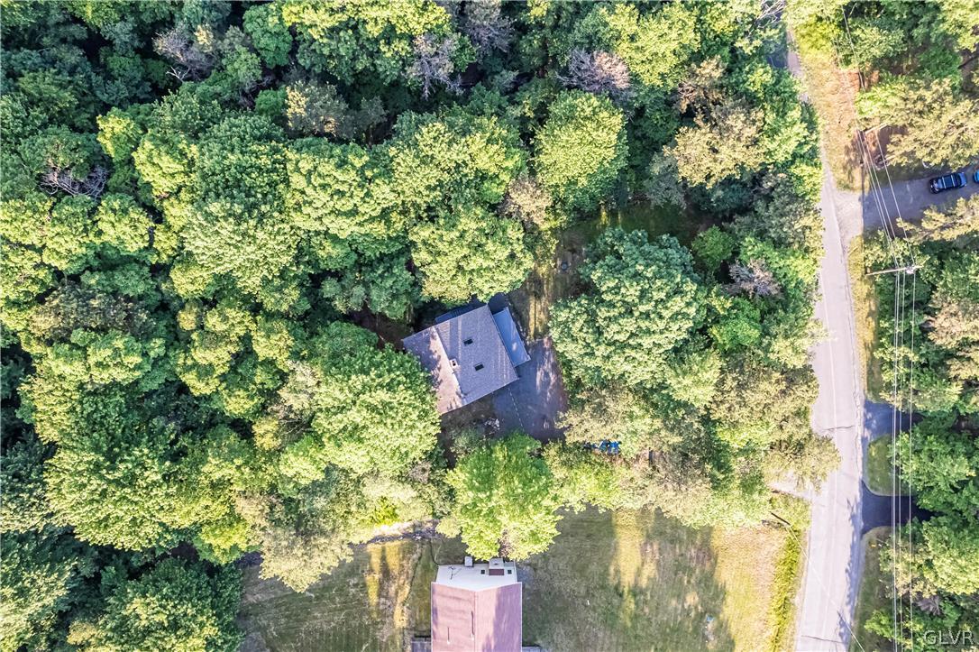 1460 Clover Road Long Pond, PA 18334 - Photo 3 of 25 an aerial view of a house with a yard and large trees
