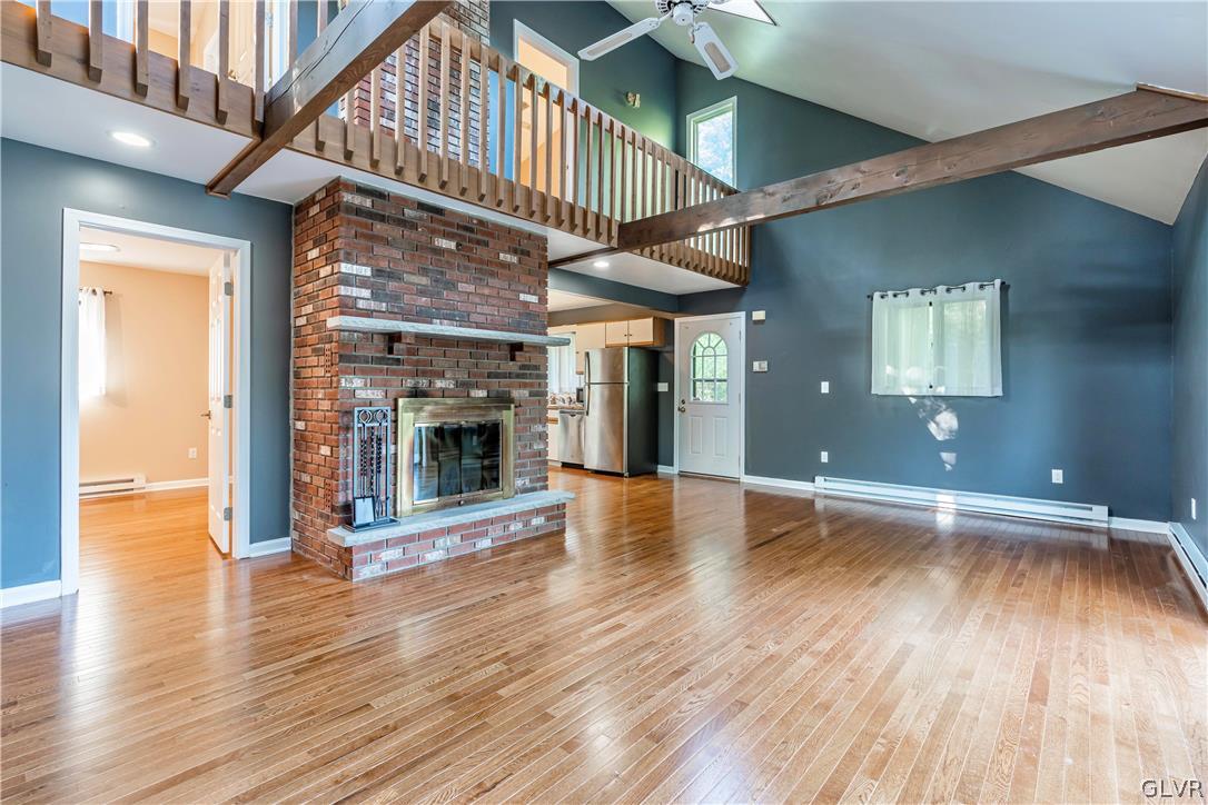1460 Clover Road Long Pond, PA 18334 - Photo 4 of 25 wooden floor in an empty room with a fireplace