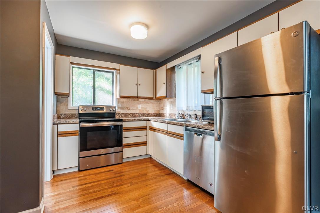 1460 Clover Road Long Pond, PA 18334 - Photo 6 of 25 a kitchen with a refrigerator and a stove top oven