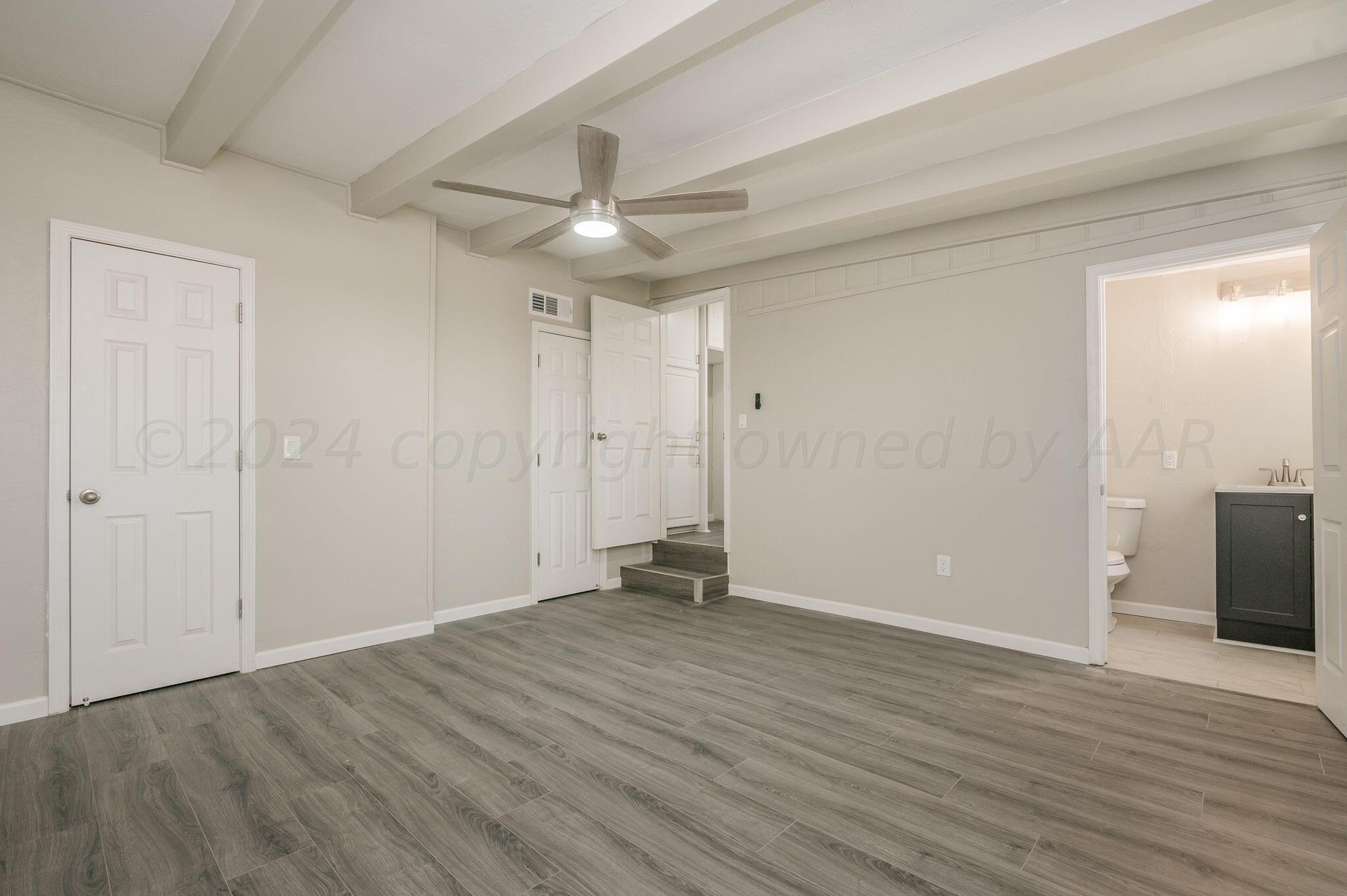 4013 South Jackson Street Amarillo, TX 79110 - Photo 13 of 18 an empty room with wooden floor and windows