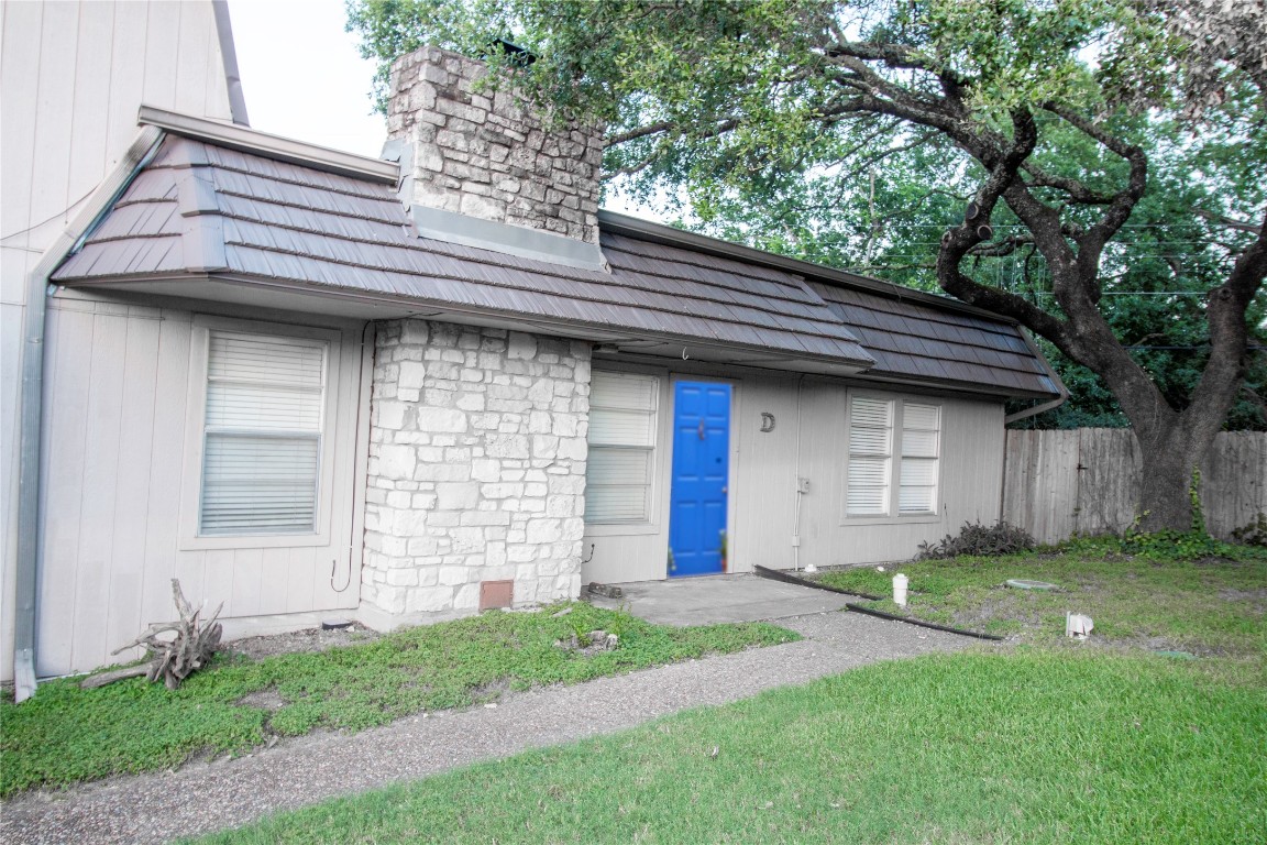 a front view of a house with a garden and yard