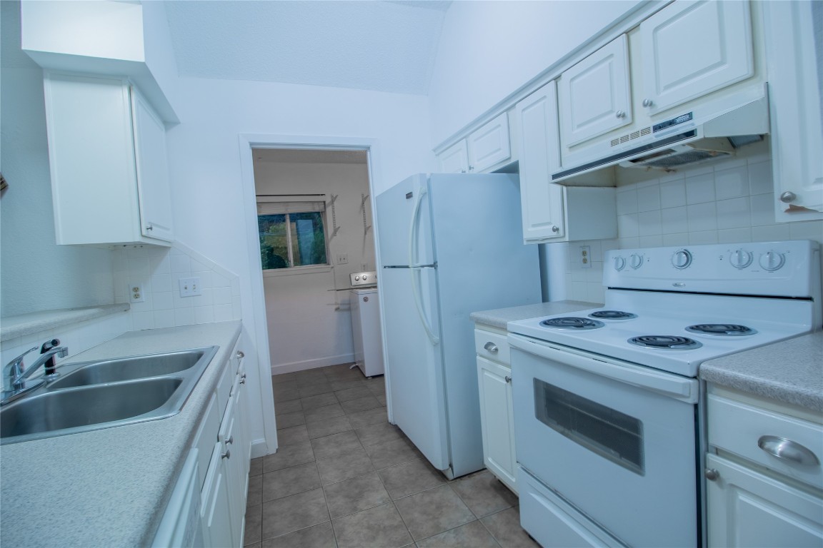 709 Castle Ridge Road, Unit D Austin, TX 78746 - Photo 12 of 19 a kitchen with a sink stove and refrigerator