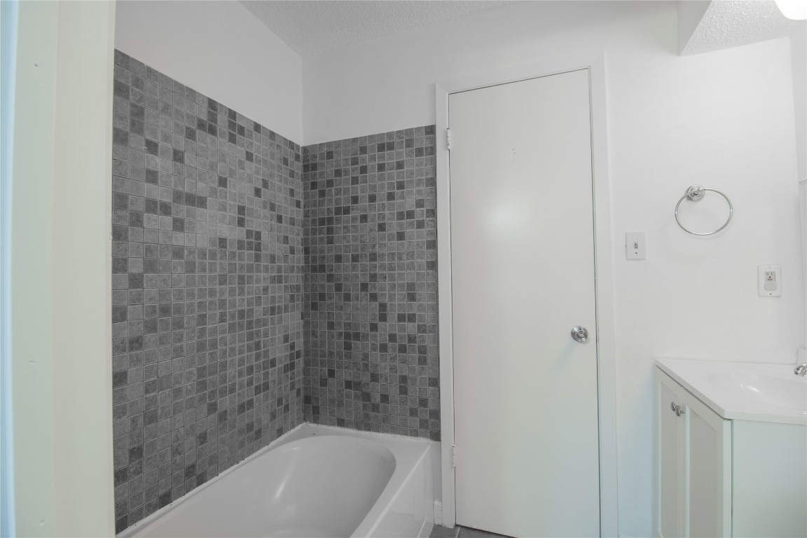 709 Castle Ridge Road, Unit D Austin, TX 78746 - Photo 16 of 19 a bathroom with a bathtub and shower