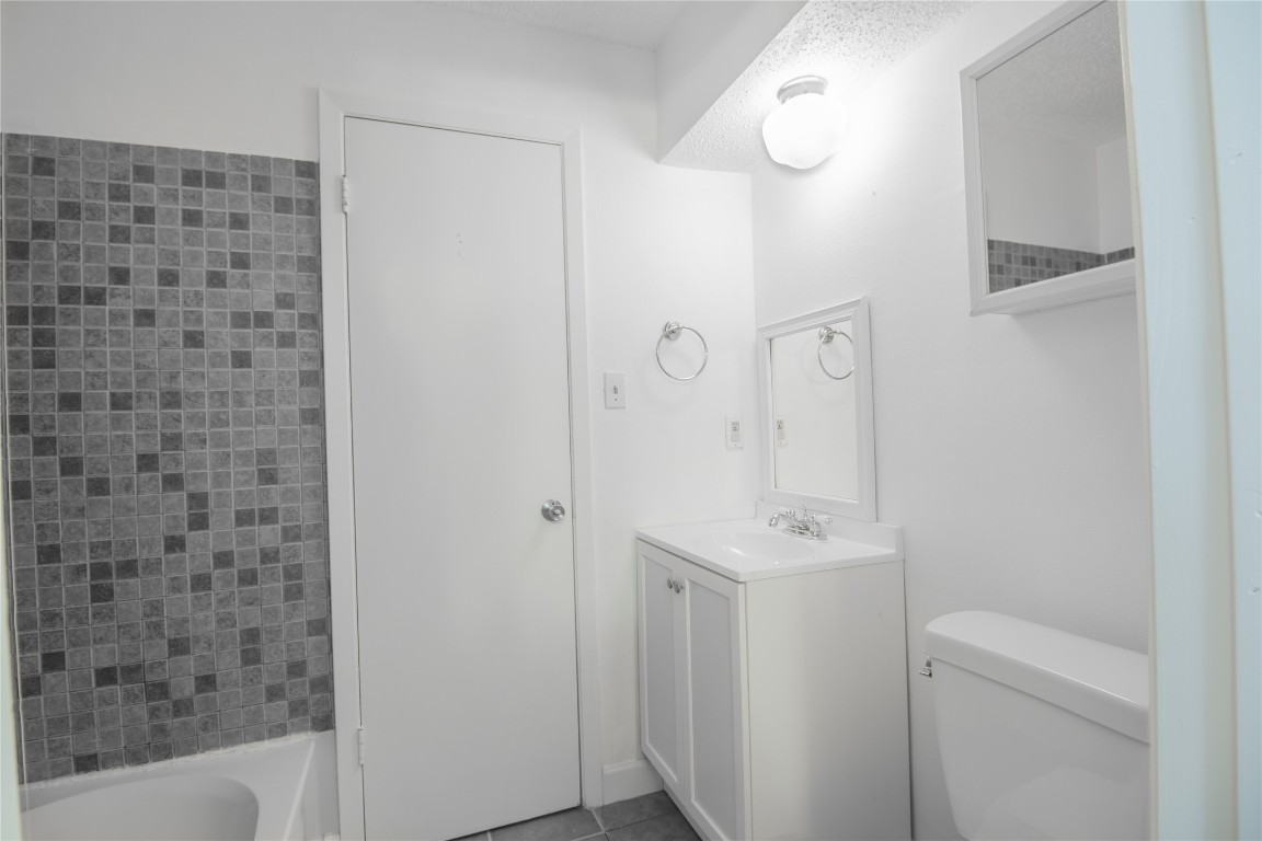 709 Castle Ridge Road, Unit D Austin, TX 78746 - Photo 17 of 19 a bathroom with a sink a toilet and shower