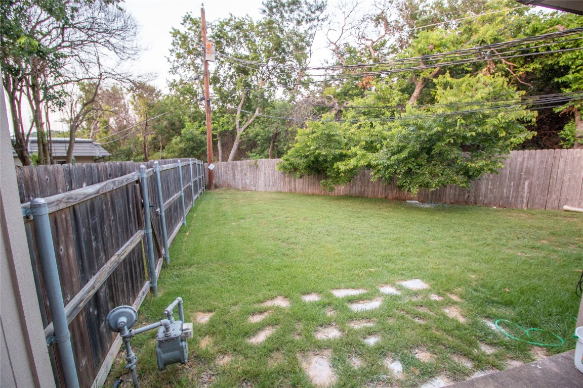 709 Castle Ridge Road, Unit D Austin, TX 78746 - Photo 3 of 19 a view of yard with swimming pool and wooden fence
