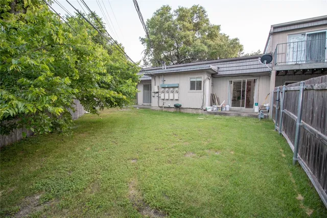 a view of a house with a yard and sitting area