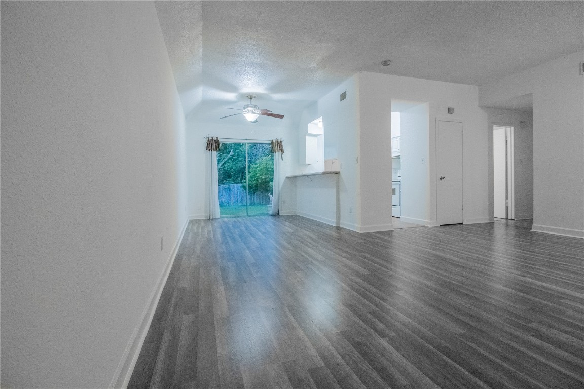 709 Castle Ridge Road, Unit D Austin, TX 78746 - Photo 5 of 19 wooden floor in an empty room with a window