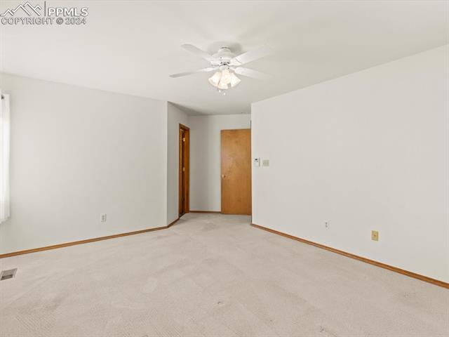 7590 Julynn Road Colorado Springs, CO 80919 - Photo 32 of 44 Spare room featuring light carpet and ceiling fan