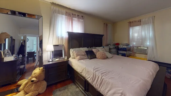 a bed room with a bed and a television