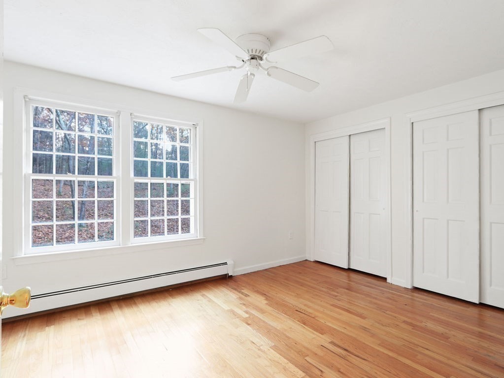 97 Pine Street Medfield, MA 02052 - Photo 21 of 29 an empty room with wooden floor and windows