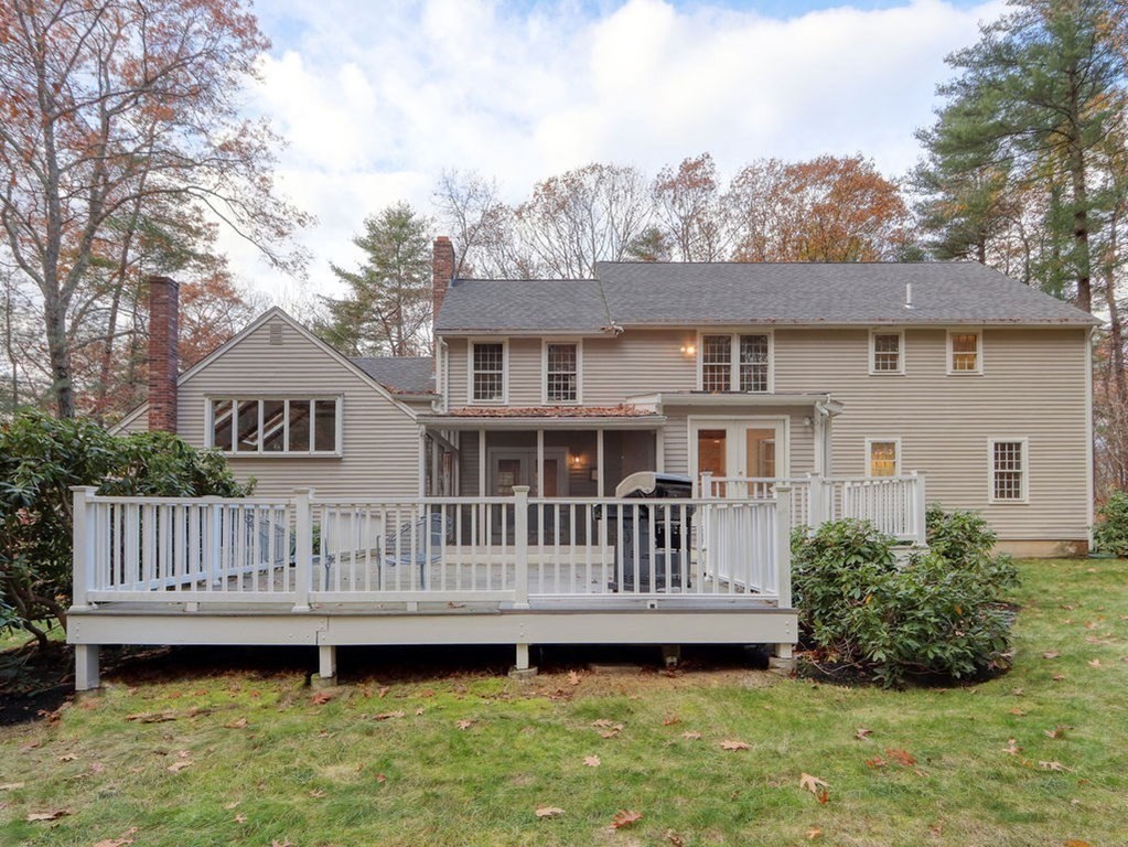 97 Pine Street Medfield, MA 02052 - Photo 26 of 29 a view of a house with a wooden deck and a yard with a fountain