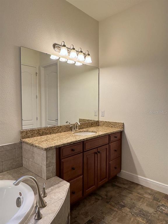 416 Blue Birch Court Sanford, FL 32771 - Photo 18 of 36 a bathroom with a sink and a mirror