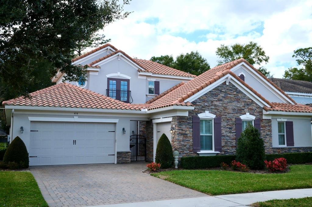 416 Blue Birch Court Sanford, FL 32771 - Photo 2 of 36 a front view of a house with a yard and garage