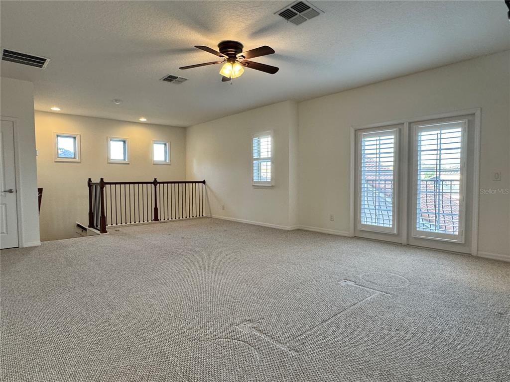 416 Blue Birch Court Sanford, FL 32771 - Photo 27 of 36 an empty room with chandelier fan and windows
