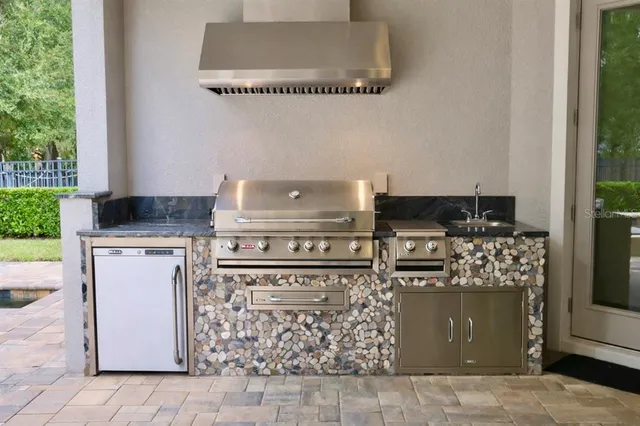a kitchen with a stove top oven and cabinets