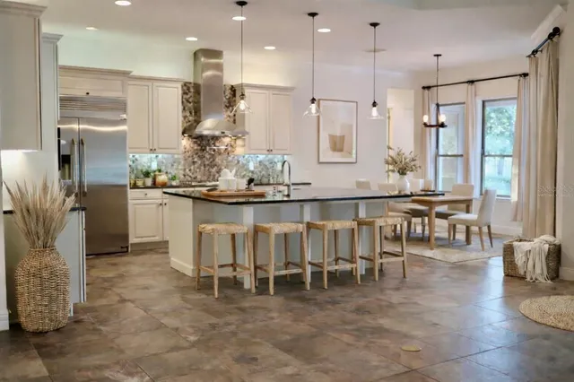 a kitchen with kitchen island granite countertop a table and chairs in it