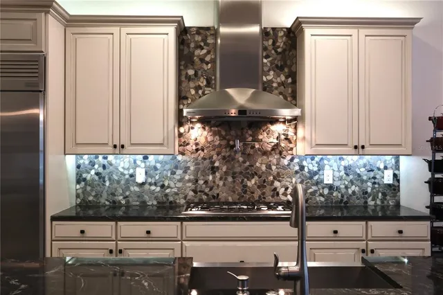 a bathroom with a granite countertop sink and mirror
