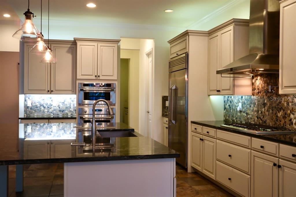 416 Blue Birch Court Sanford, FL 32771 - Photo 9 of 36 a kitchen with stainless steel appliances granite countertop a refrigerator and cabinets