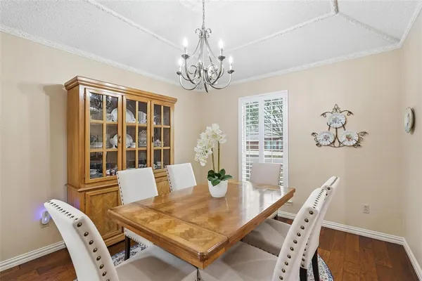 a view of a dining room with furniture and a chandelier