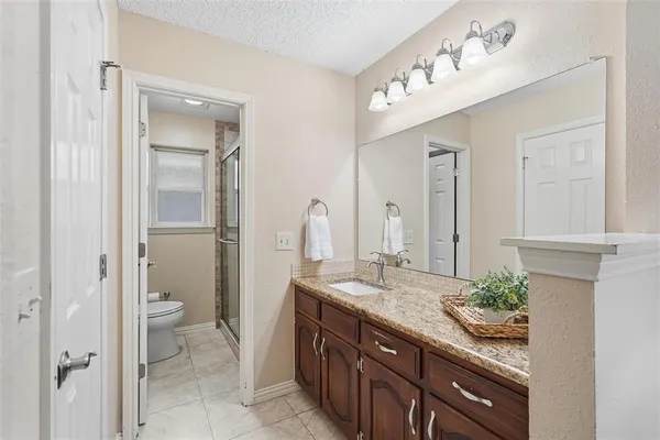 a bathroom with a glass shower door