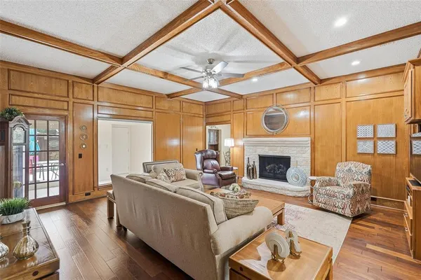 a living room with furniture a fireplace and a large window